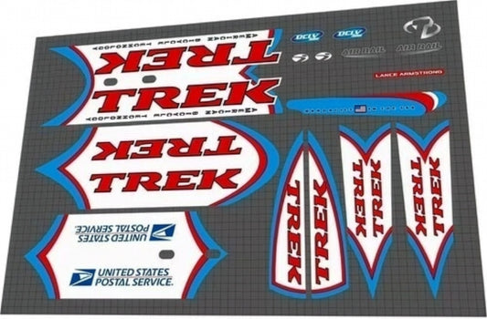 Trek bicycle decals on a gray surface with logos of various companies.